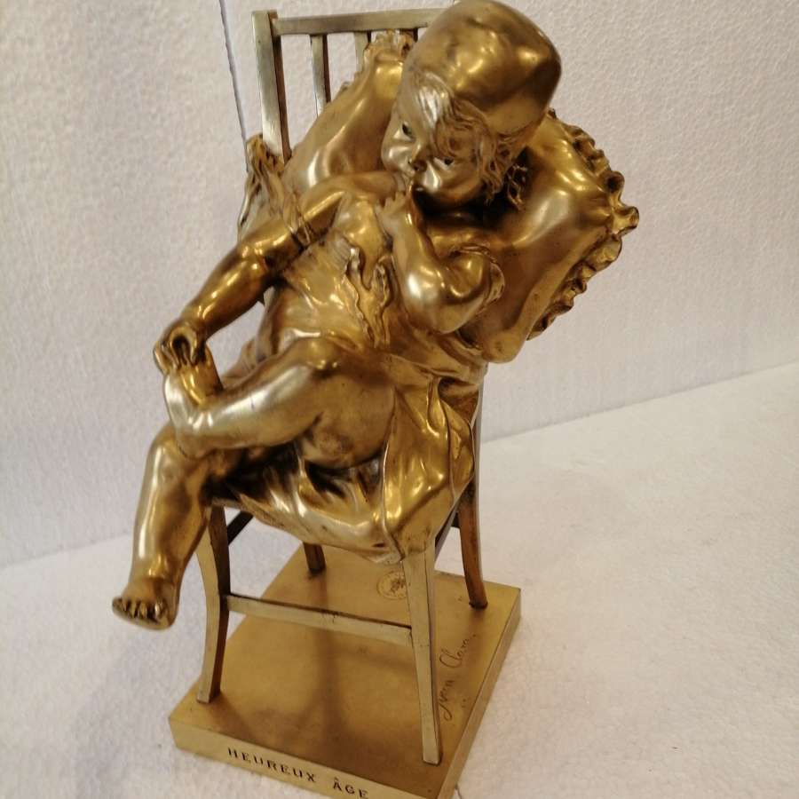 An Enchanting Gilt Bronze Figure Of A Seated Child