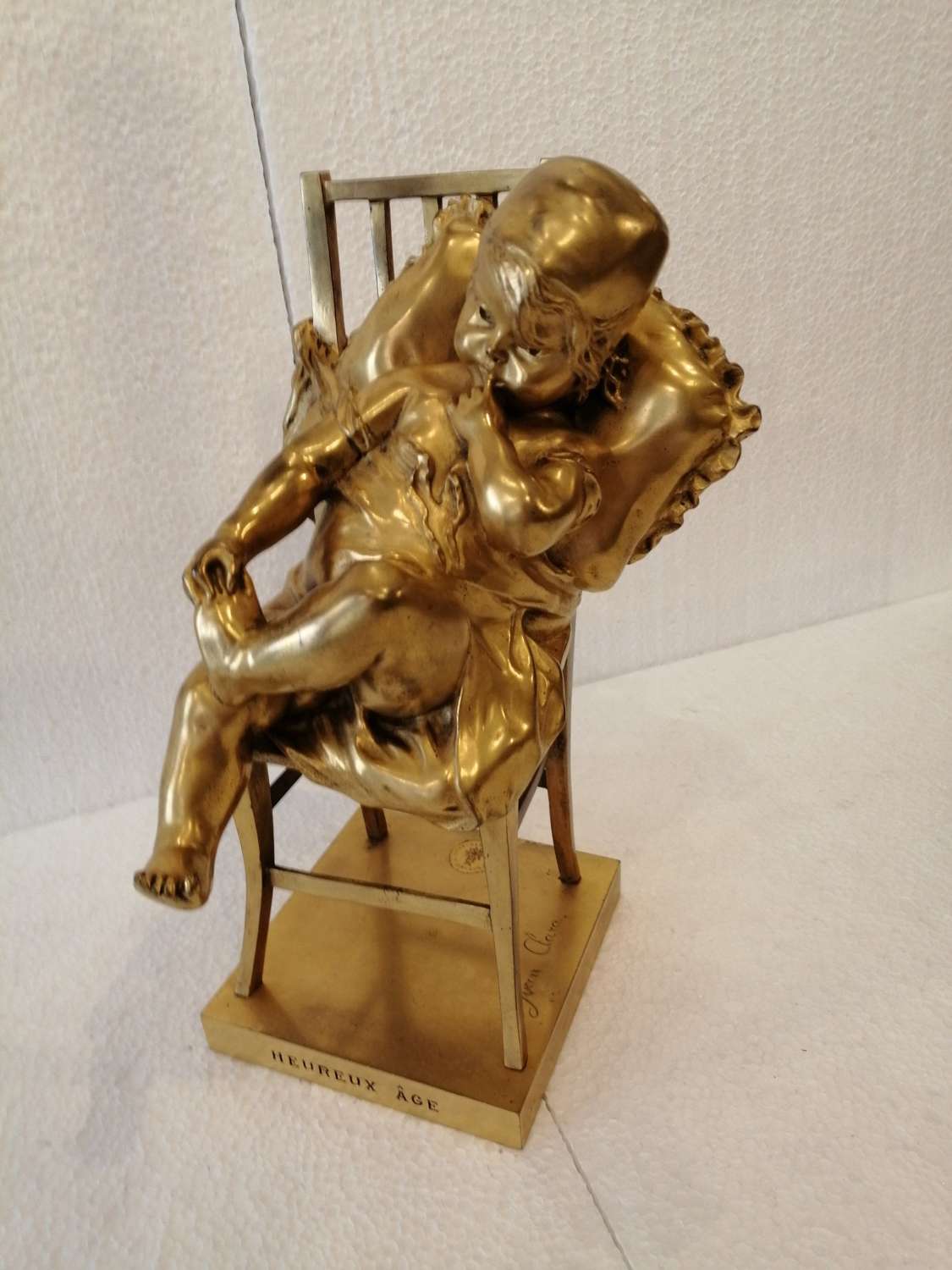 An Enchanting Gilt Bronze Figure Of A Seated Child