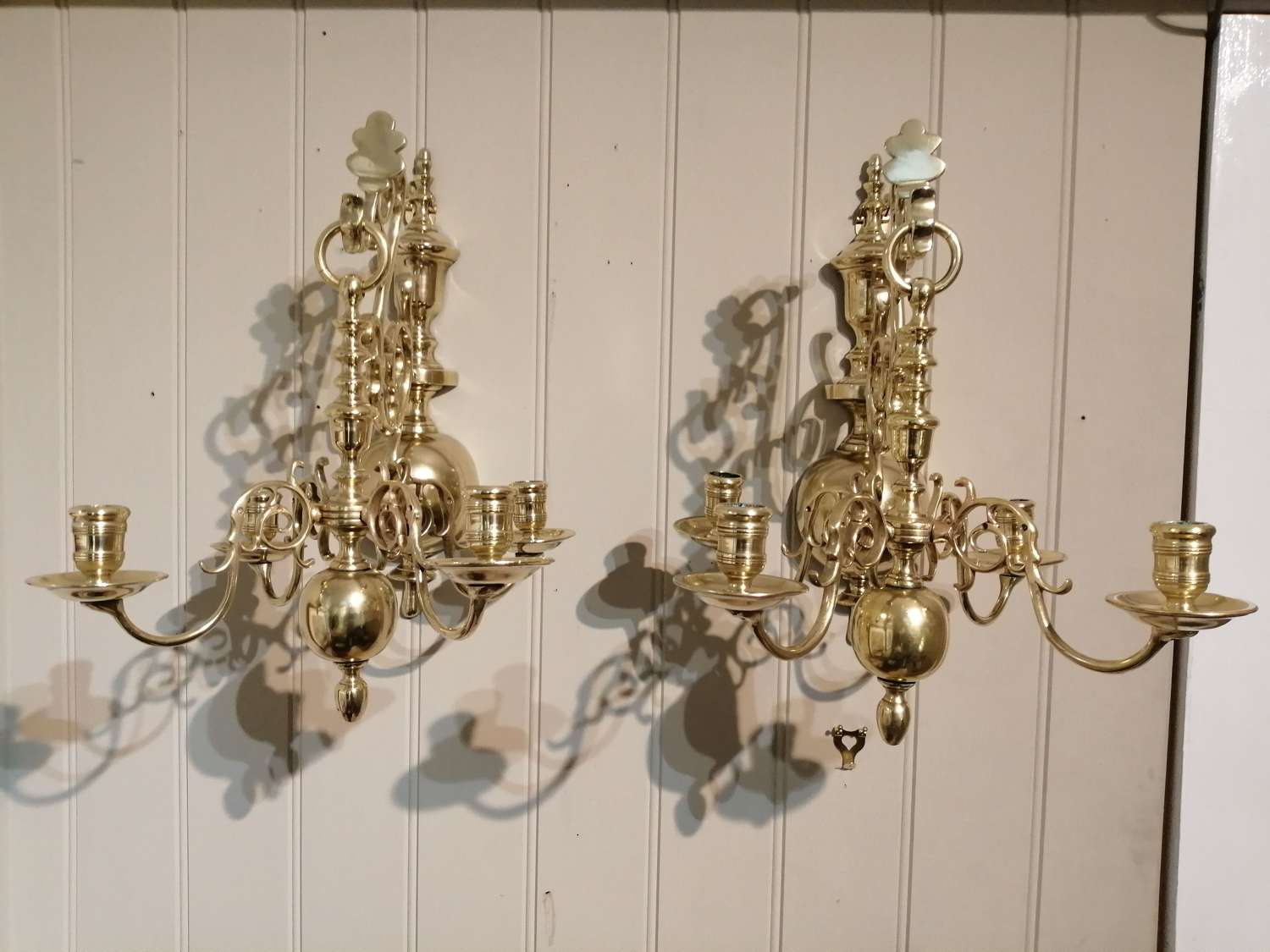 A most unusual pair of French brass chandelier wall lights