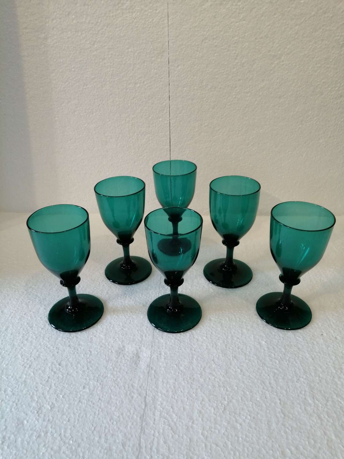 A set of six Georgian Bristol green wine glasses