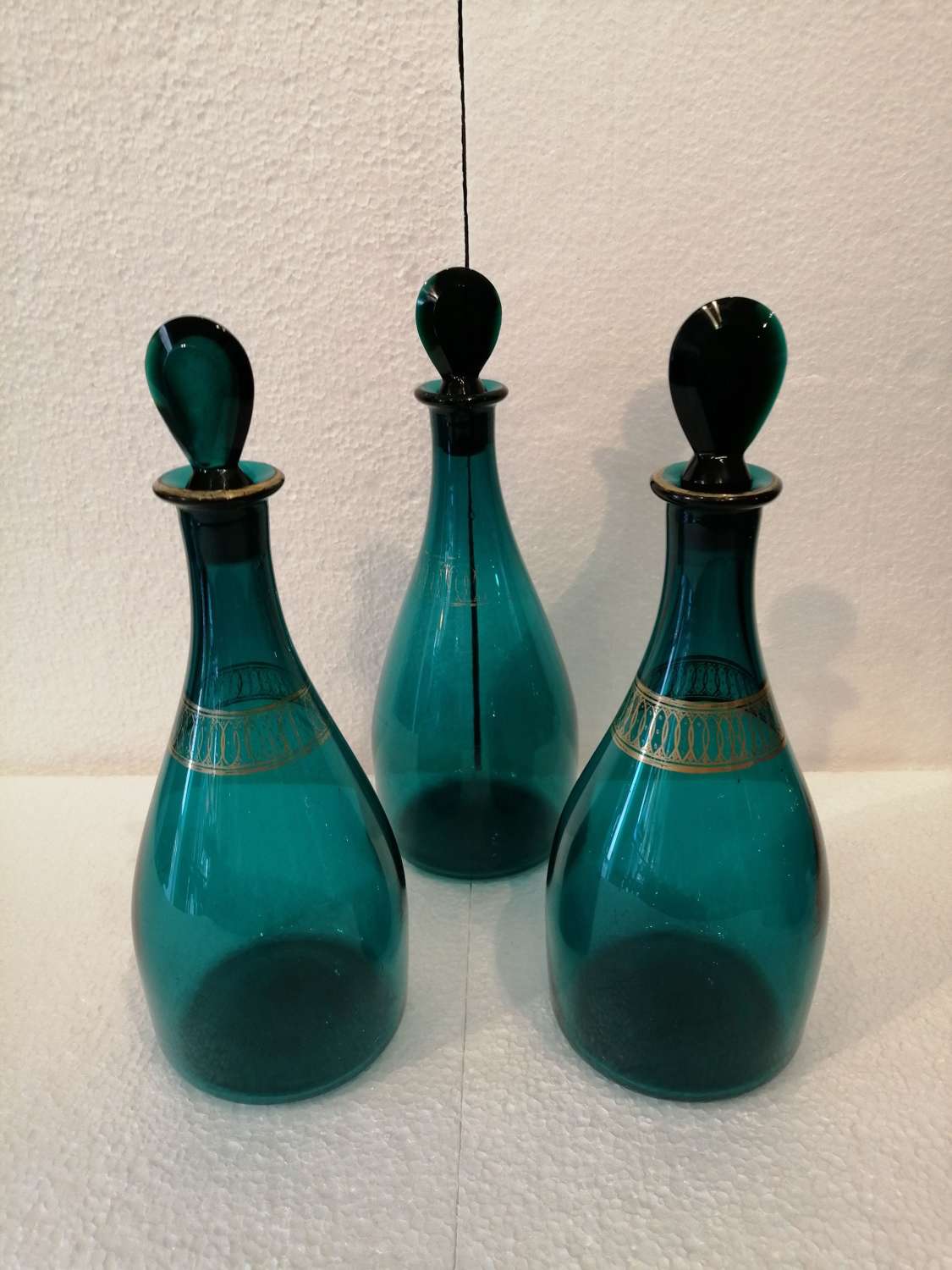 Set of three Georgian peacock blue decanters