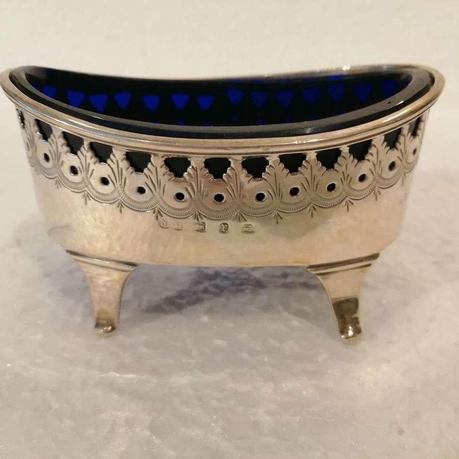 A n oval silver salt with blue liner
