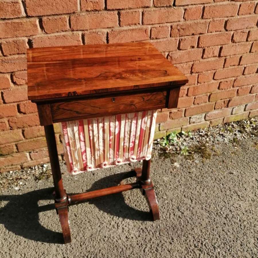 A beautifully marked Regency rosewood work table