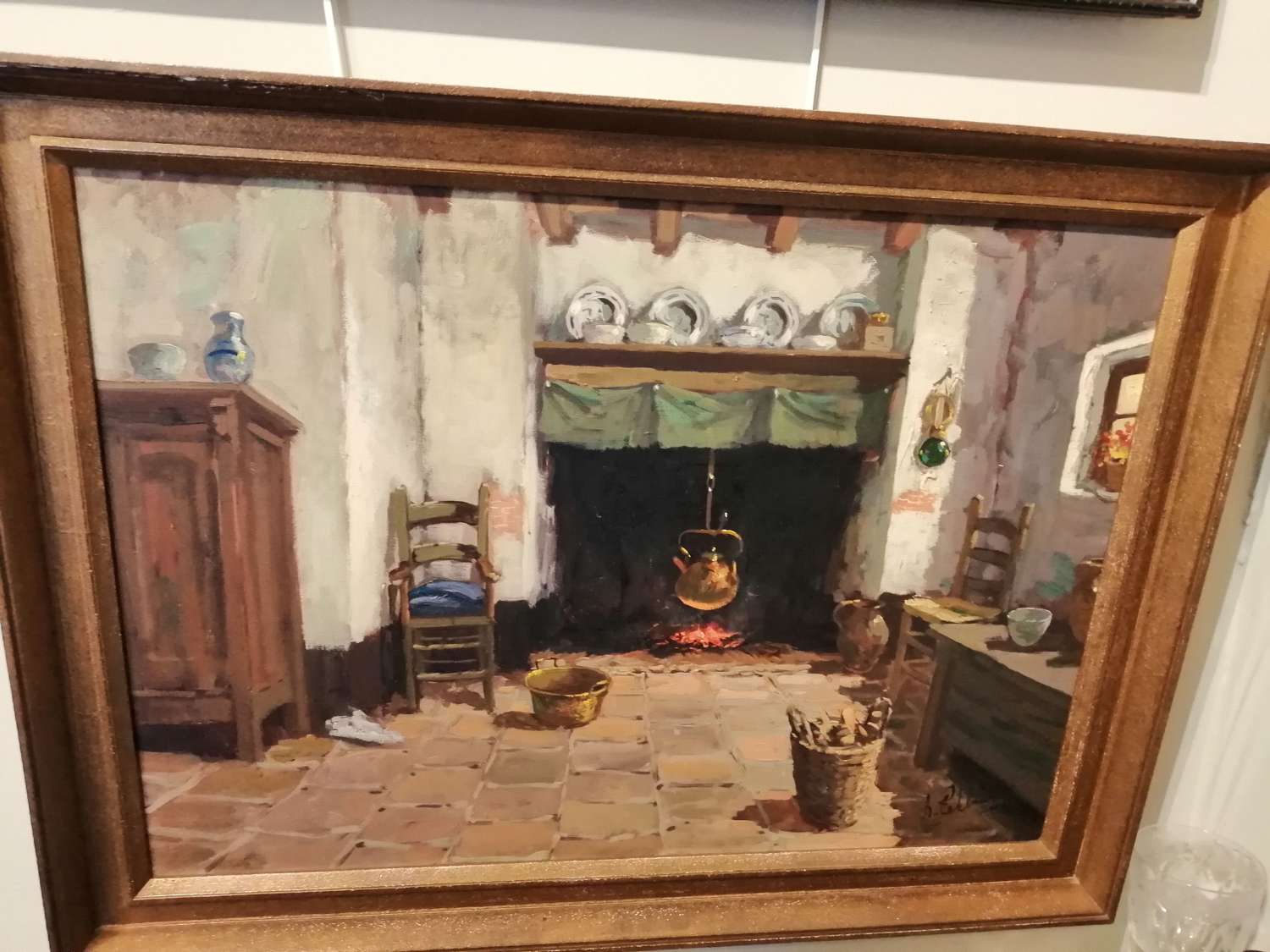 An interesting oil on canvas of a rustic country kitchen