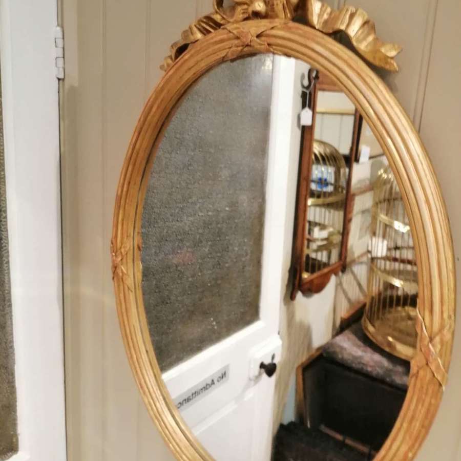 An attractive 19th century French gilded oval mirror