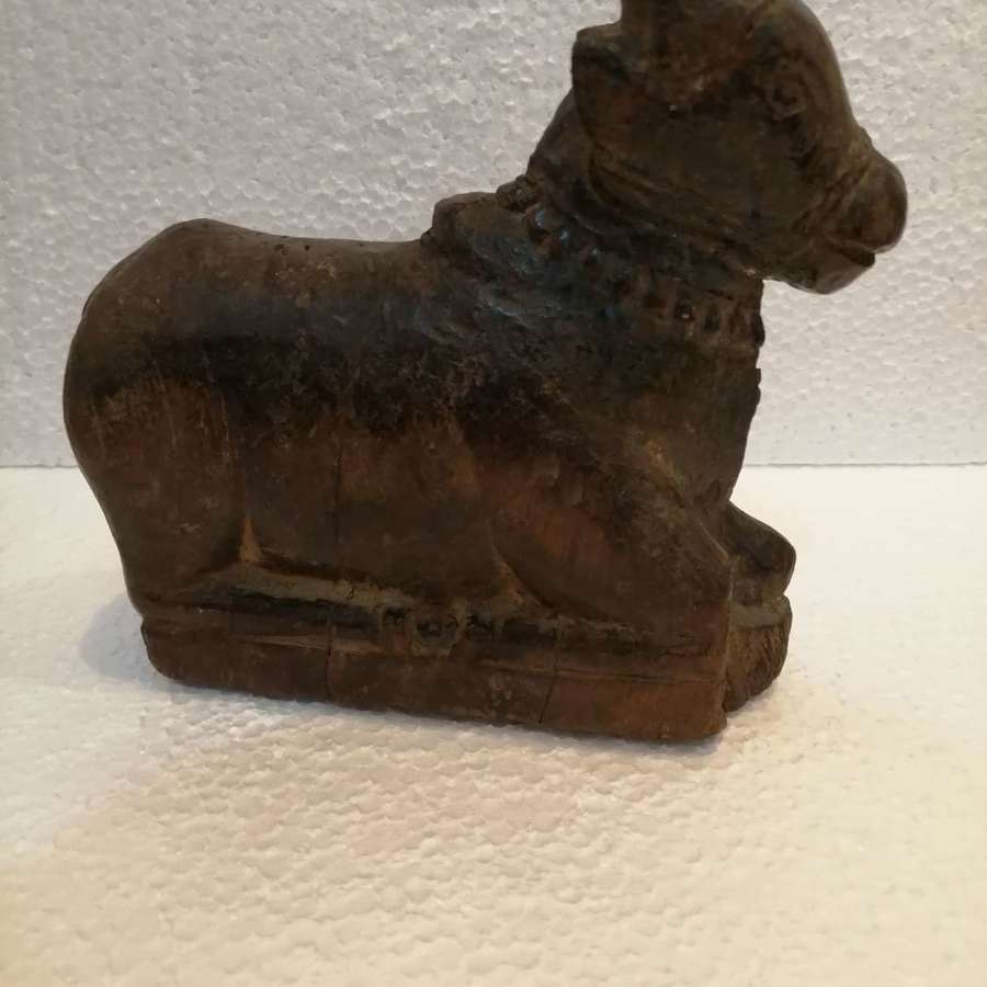 A 17th century wooden carving of a Nandi seated bull