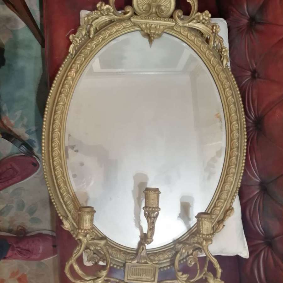 A French gilded Louis XVI oval girandole mirror