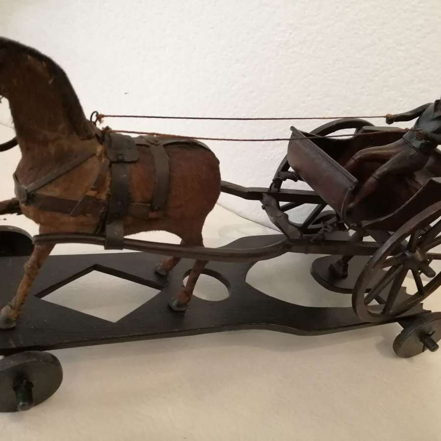 A 19th century folk art model of a horse drawn gig/buggy
