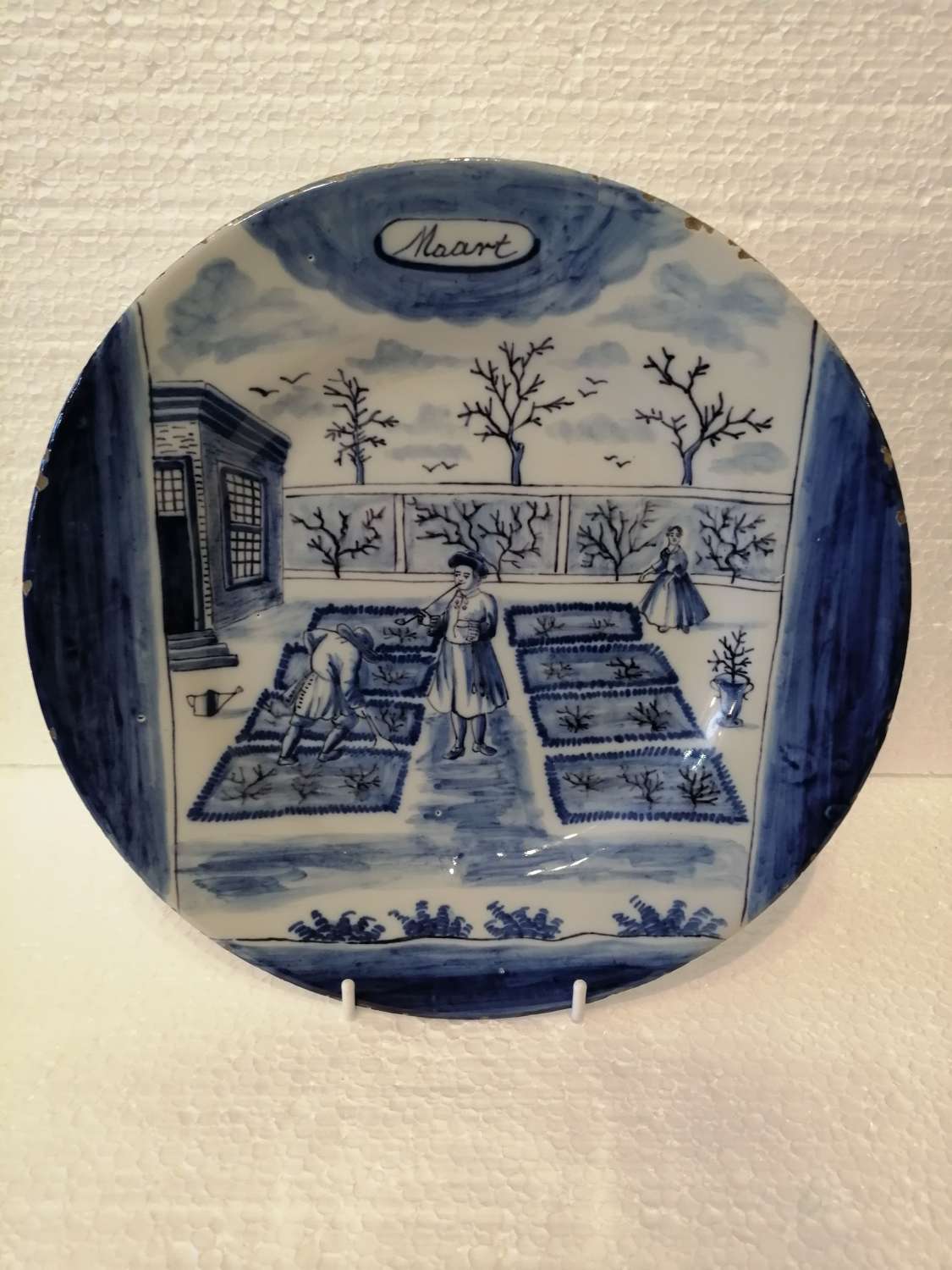 An 18th century Dutch Delft blue & white plate: March