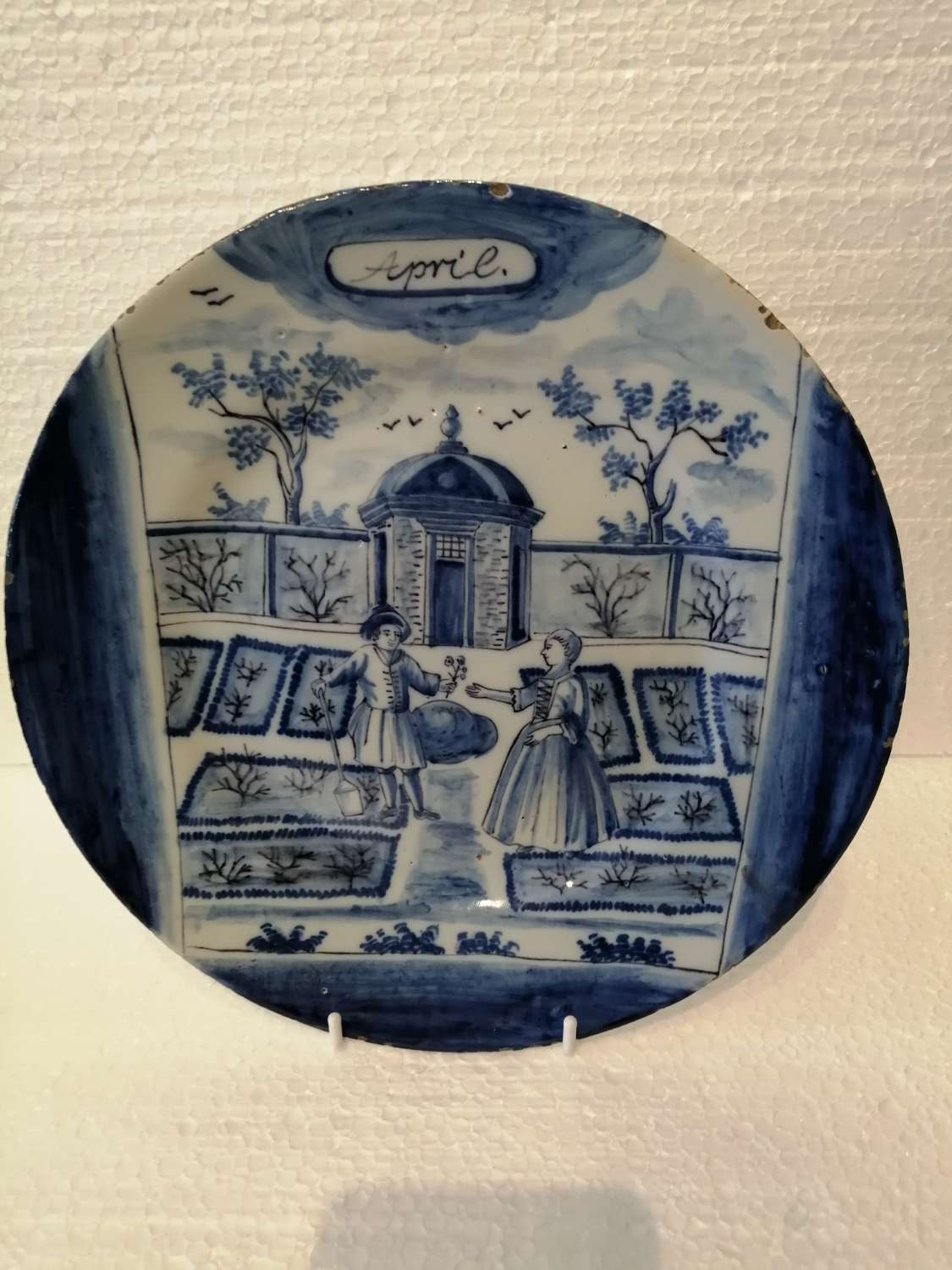 An 18th century Dutch Delft blue & white plate: April