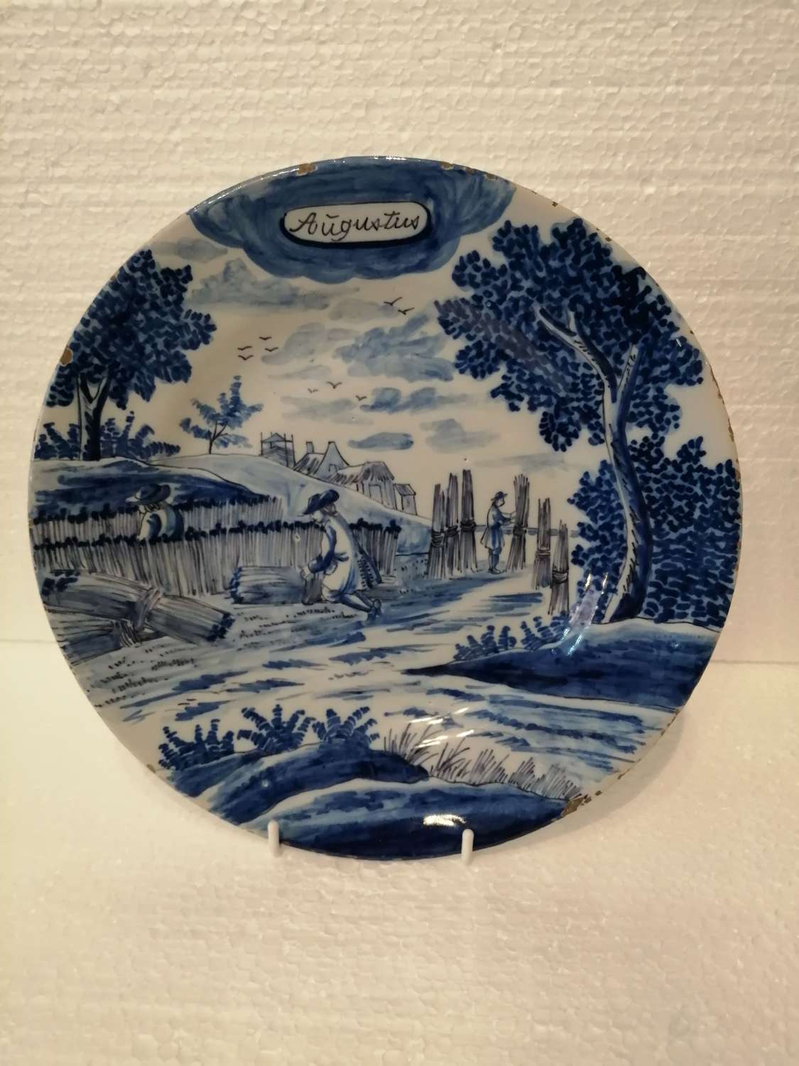 An 18th century Dutch Delft blue & white plate: August