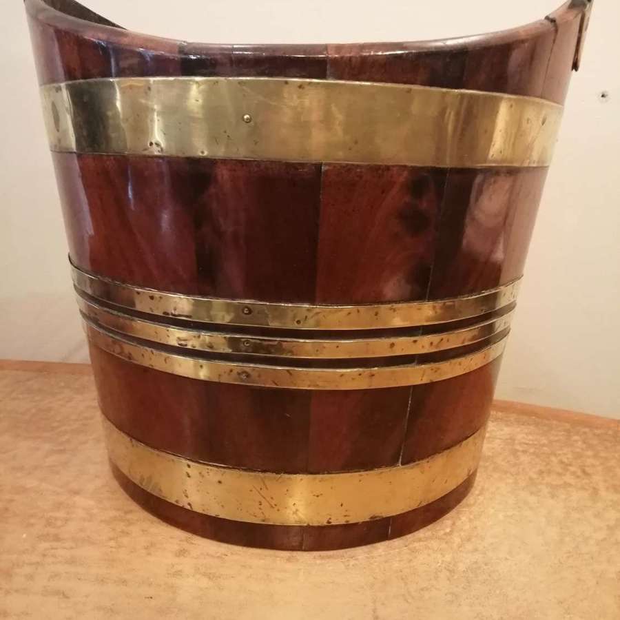 A Georgian mahogany brass bound bucket