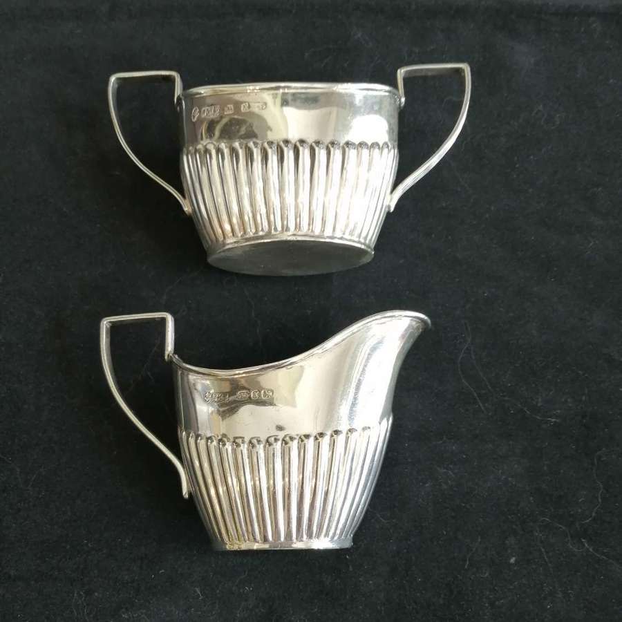 A silver cream jug  and sugar bowl
